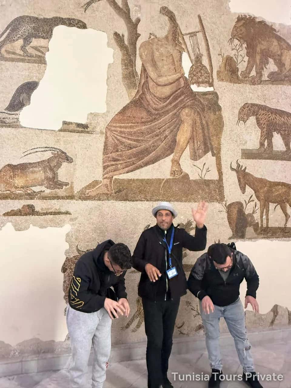 A guide and two guests in front of the Orpheus mosaic at the Bardo National Museum