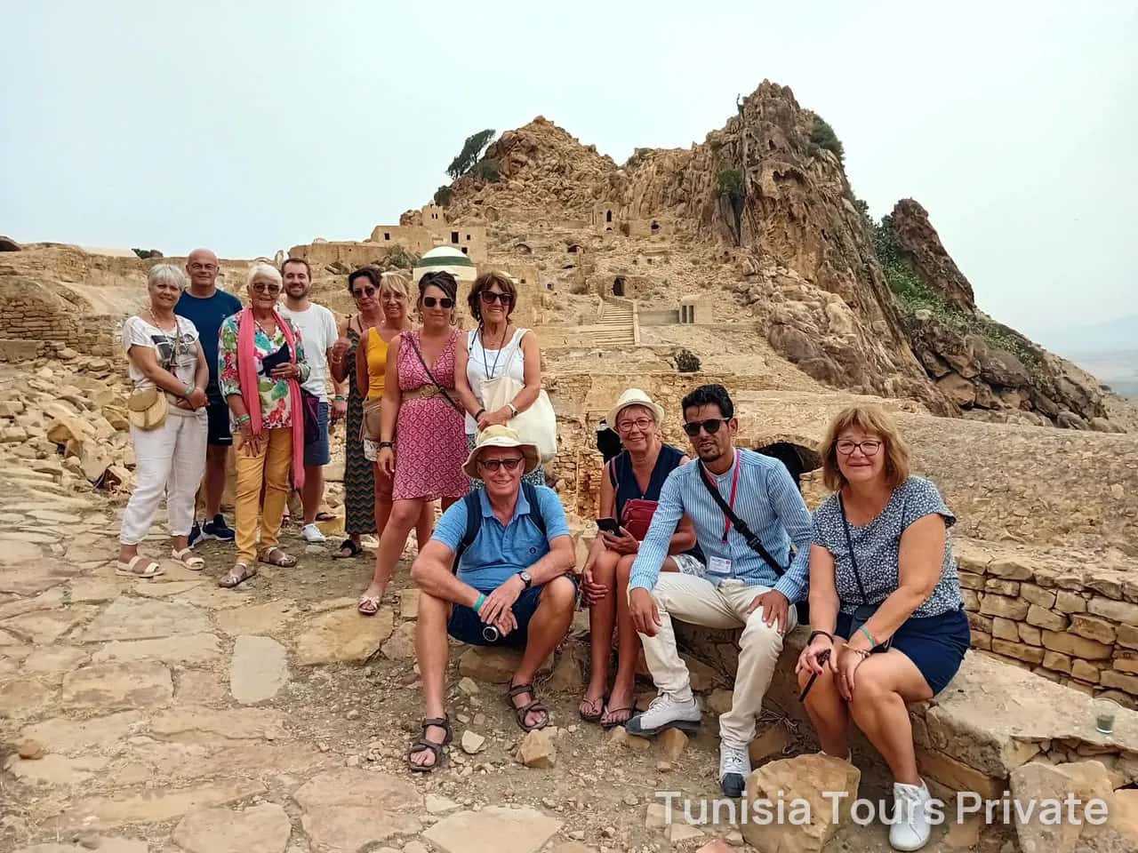A group resting on the stones of a hilltop Berber village in the south
