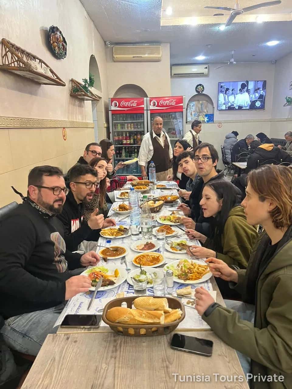 Guests sharing a Tunisian lunch at a long table