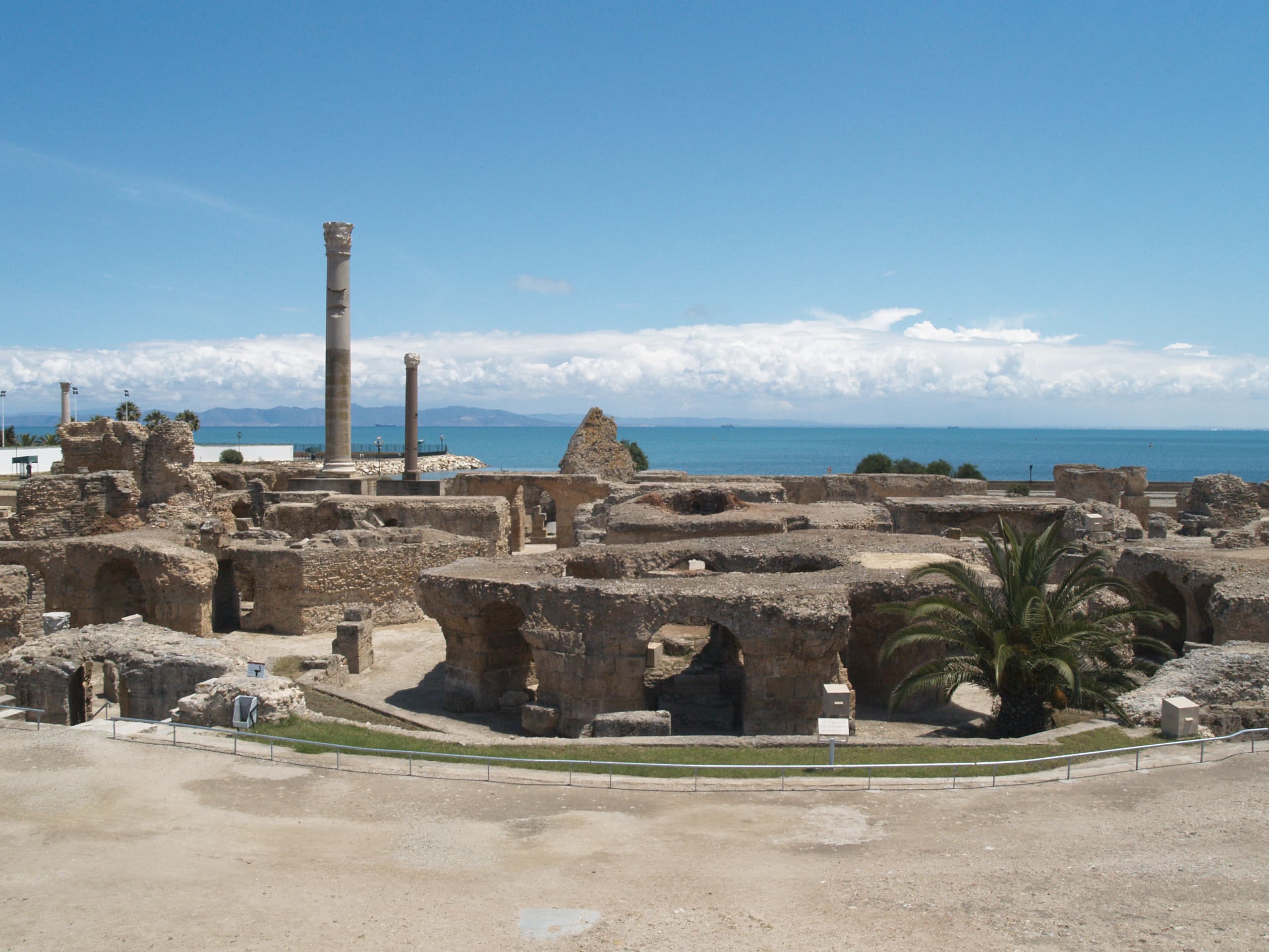 A standing column of the Antonine Baths in Carthage, with the sea behind