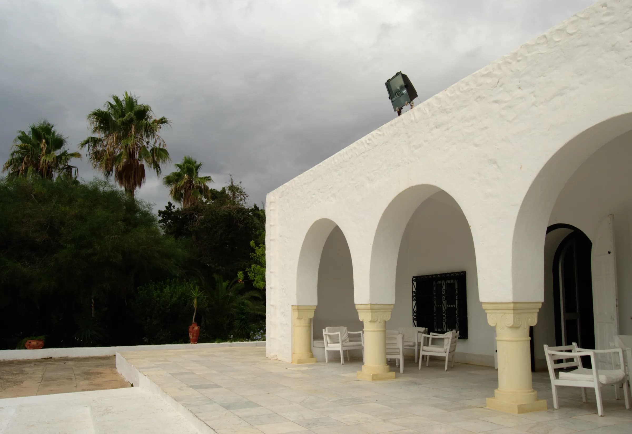 The white arcade of Dar Sebastian among palm trees, Hammamet