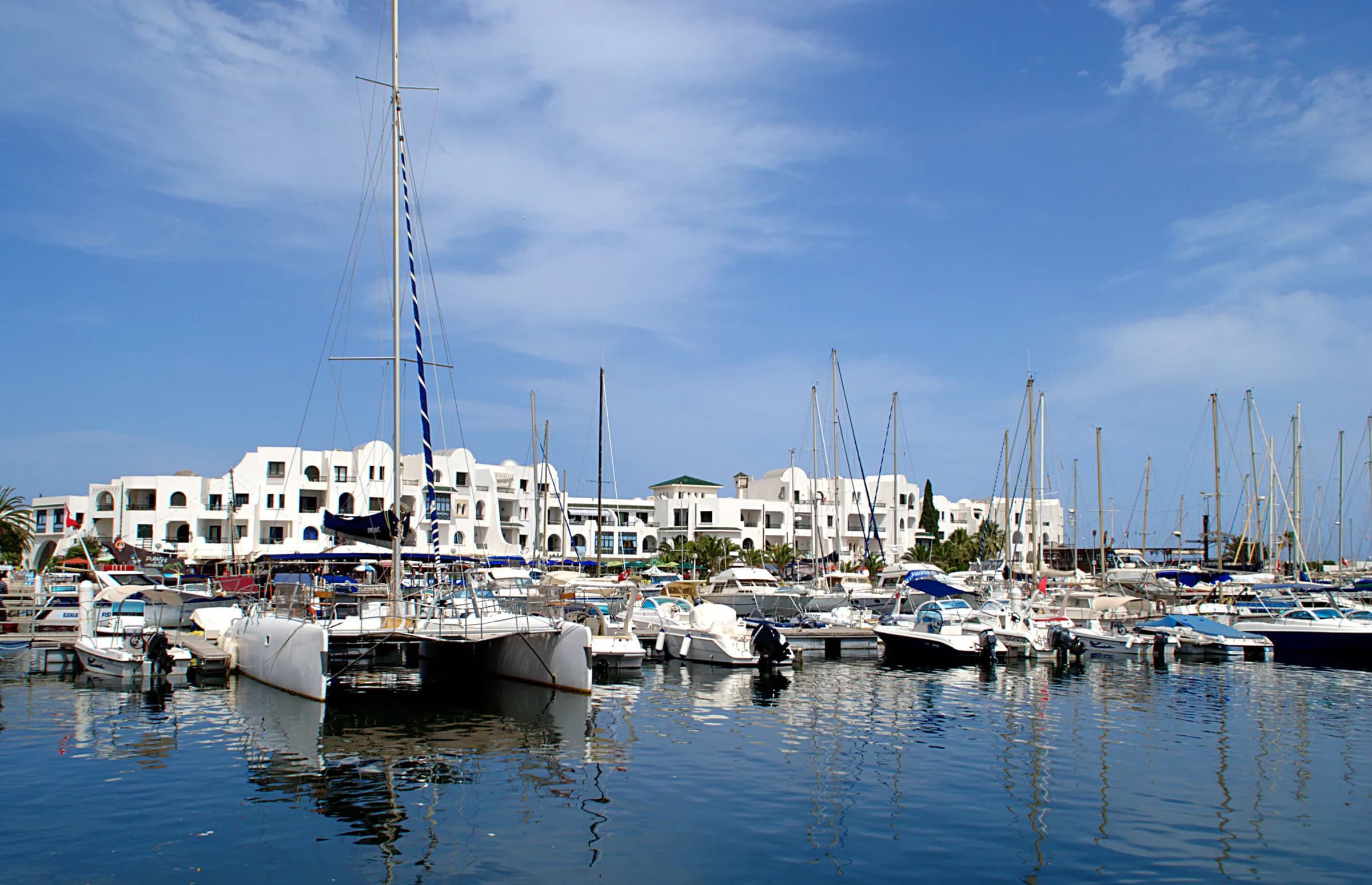 Yachts in the marina of Port El Kantaoui, with white buildings along the quay